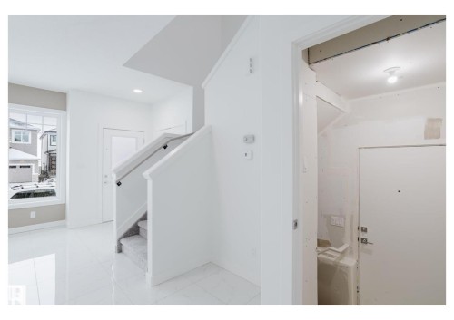 Hallway featuring recessed lighting, stairs, and light marble finish floors - 231 25 Street Sw, Edmonton, AB - Indoor