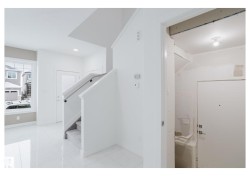 Hallway featuring recessed lighting, stairs, and light marble finish floors - 