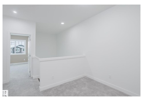 Empty room featuring light carpet and recessed lighting - 231 25 Street Sw, Edmonton, AB - Indoor Photo Showing Other Room