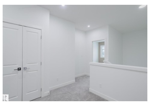 Corridor featuring light carpet, an upstairs landing, and recessed lighting - 231 25 Street Sw, Edmonton, AB - Indoor Photo Showing Other Room