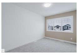 Carpeted spare room featuring baseboards - 