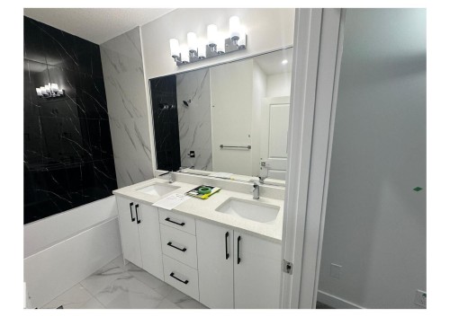 Bathroom with light marble finish flooring, double vanity, a combined bath / shower with marble appearance, and a textured ceiling - 231 25 Street Sw, Edmonton, AB - Indoor Photo Showing Bathroom