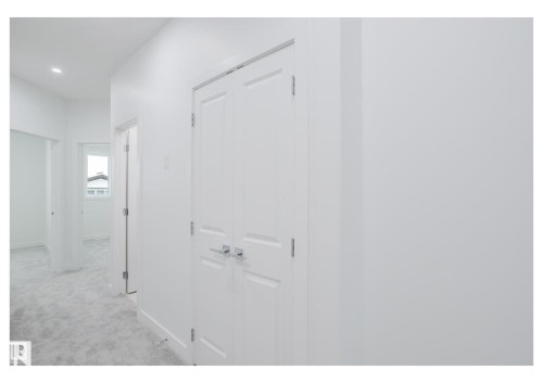 Corridor featuring light colored carpet and baseboards - 231 25 Street Sw, Edmonton, AB - Indoor Photo Showing Other Room