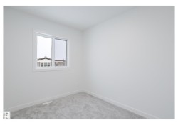 Empty room featuring baseboards and light carpet - 