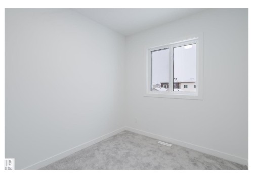 Spare room with baseboards and light carpet - 231 25 Street Sw, Edmonton, AB - Indoor Photo Showing Other Room