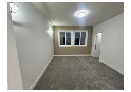 Unfurnished room with baseboards and dark colored carpet - 231 25 Street Sw, Edmonton, AB - Indoor Photo Showing Other Room