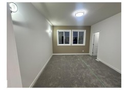 Unfurnished room with baseboards and dark colored carpet - 