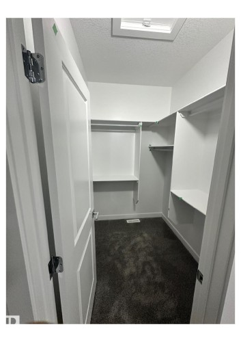 Spacious closet with dark colored carpet - 231 25 Street Sw, Edmonton, AB - Indoor With Storage