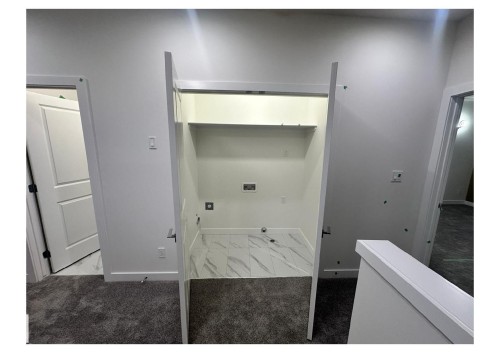 Laundry area featuring light marble finish flooring, hookup for an electric dryer, and gas dryer hookup - 231 25 Street Sw, Edmonton, AB - Indoor Photo Showing Other Room