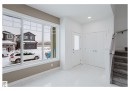 Foyer featuring stairs, recessed lighting, and light marble finish flooring - 231 25 Street Sw, Edmonton, AB  - Indoor Photo Showing Other Room 