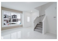 Foyer entrance with stairs and recessed lighting - 