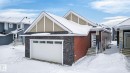 View of front facade with stone siding, entry steps, and a garage - 3318 Chickadee Drive, Edmonton, AB  - Outdoor With Facade 