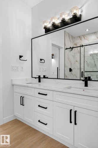 Full bath featuring double vanity, a marble finish shower, and light wood-style floors - 3318 Chickadee Drive, Edmonton, AB - Indoor Photo Showing Other Room