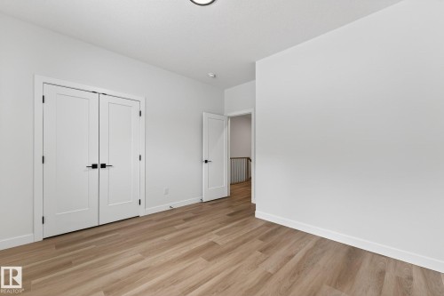 Unfurnished bedroom with light wood-style floors and a closet - 3318 Chickadee Drive, Edmonton, AB - Indoor Photo Showing Other Room