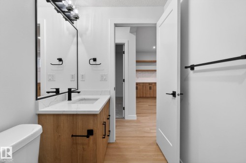 Bathroom with vanity and light wood-style flooring - 3318 Chickadee Drive, Edmonton, AB - Indoor Photo Showing Bathroom