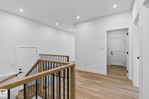 Hallway with an upstairs landing, light wood-style flooring, and recessed lighting - 3318 Chickadee Drive, Edmonton, AB - Indoor Photo Showing Other Room