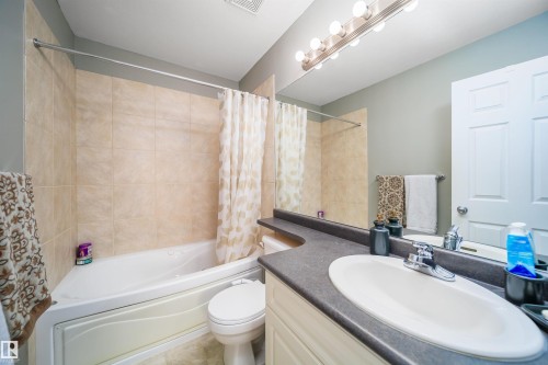 Bathroom featuring vanity and shower / bath combo with shower curtain - 1179 Oakland Drive, Devon, AB - Indoor Photo Showing Bathroom