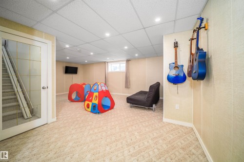 Rec room with a paneled ceiling, recessed lighting, and carpet flooring - 1179 Oakland Drive, Devon, AB - Indoor Photo Showing Basement