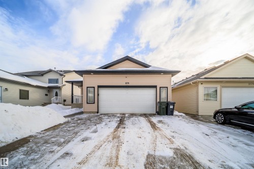 View of front of property featuring a garage - 1179 Oakland Drive, Devon, AB - Outdoor With Facade
