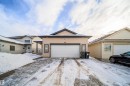 View of front of property featuring a garage - 1179 Oakland Drive, Devon, AB  - Outdoor With Facade 