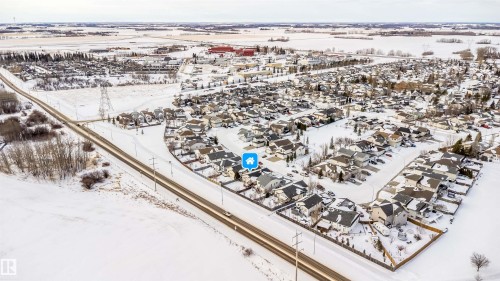 Snowy aerial view featuring a residential view - 1179 Oakland Drive, Devon, AB - Outdoor With View