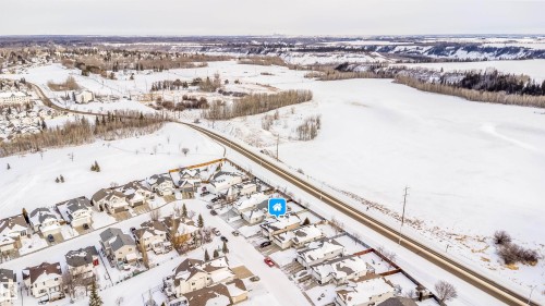 Snowy aerial view featuring a residential view - 1179 Oakland Drive, Devon, AB - Outdoor With View