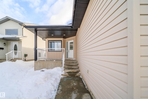 View of snow covered property entrance - 1179 Oakland Drive, Devon, AB - Outdoor With Deck Patio Veranda With Exterior