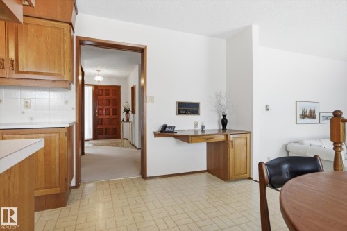 Kitchen featuring wood finish cabinets, brick patterned floors, and light countertops - 65 Lorne Crescent, St. Albert, AB - Indoor