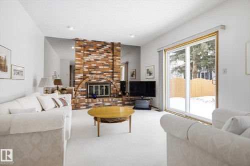 Carpeted living room featuring a fireplace - 65 Lorne Crescent, St. Albert, AB - Indoor Photo Showing Living Room With Fireplace
