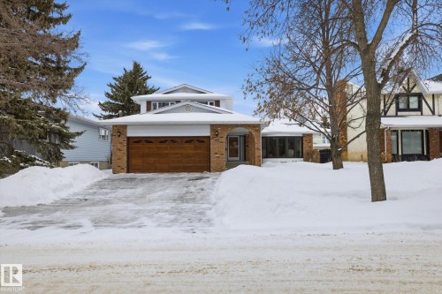 View of front facade with brick siding and an attached garage - 65 Lorne Crescent, St. Albert, AB - Outdoor With Facade