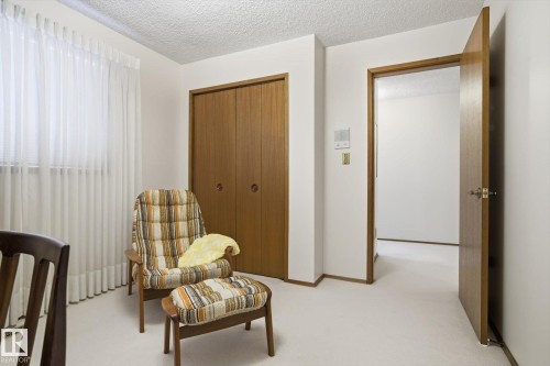 Bedroom with a textured ceiling, a closet, and light carpet - 65 Lorne Crescent, St. Albert, AB - Indoor