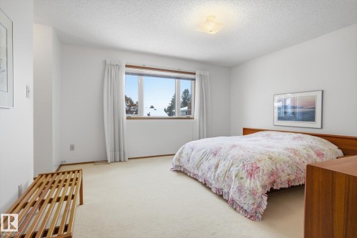Bedroom with light colored carpet and a textured ceiling - 65 Lorne Crescent, St. Albert, AB - Indoor Photo Showing Bedroom