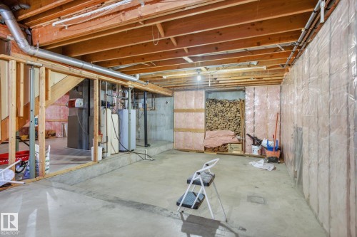 Unfinished below grade area featuring water heater - 65 Lorne Crescent, St. Albert, AB - Indoor Photo Showing Basement