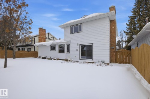 Snow covered property with a chimney and a gate - 65 Lorne Crescent, St. Albert, AB - Outdoor