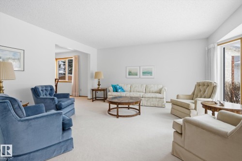 Carpeted living area with a textured ceiling - 65 Lorne Crescent, St. Albert, AB - Indoor Photo Showing Living Room