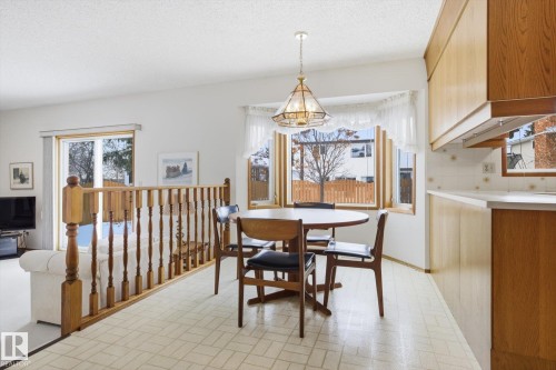 Dining area with brick patterned flooring and a textured ceiling - 65 Lorne Crescent, St. Albert, AB - Indoor Photo Showing Dining Room