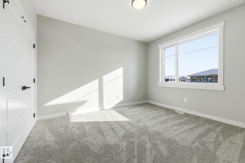 Spare room featuring carpet floors and baseboards - 28 Harley Way, Spruce Grove, AB - Indoor Photo Showing Other Room