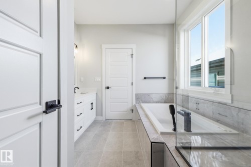 Full bath featuring vanity, a garden tub, and light tile patterned flooring - 28 Harley Way, Spruce Grove, AB - Indoor Photo Showing Bathroom