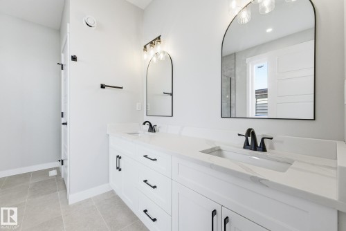 Bathroom with double vanity, light tile patterned floors, and recessed lighting - 28 Harley Way, Spruce Grove, AB - Indoor Photo Showing Bathroom