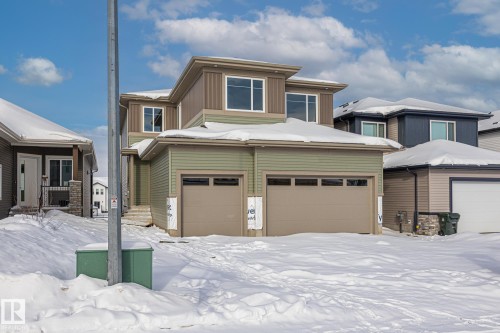 View of front facade with an attached garage and board and batten siding - 28 Harley Way, Spruce Grove, AB - Outdoor With Facade