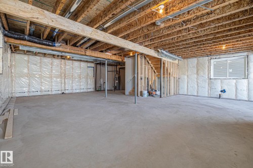 Unfinished basement featuring stairway and gas water heater - 28 Harley Way, Spruce Grove, AB - Indoor Photo Showing Basement