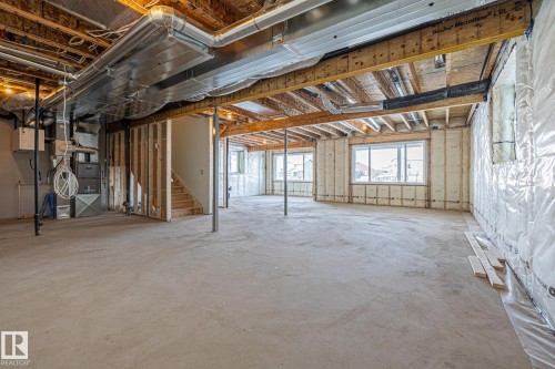 Basement with heating unit and stairs - 28 Harley Way, Spruce Grove, AB - Indoor Photo Showing Basement
