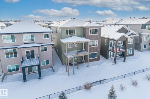 Snow covered back of property featuring a residential view, a patio area, and a gazebo - 28 Harley Way, Spruce Grove, AB - Outdoor