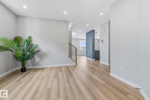 Empty room featuring light wood-style floors and recessed lighting - 28 Harley Way, Spruce Grove, AB - Indoor Photo Showing Other Room