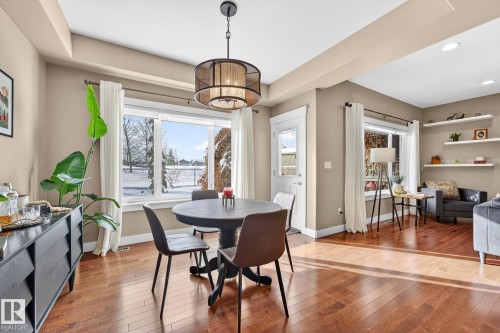 Dining space with hardwood / wood-style flooring and suspended lighting - 21 Dittrich, Fort Saskatchewan, AB - Indoor Photo Showing Dining Room
