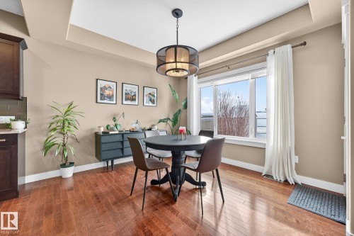Dining room with a raised ceiling and dark wood finished floors - 21 Dittrich, Fort Saskatchewan, AB - Indoor Photo Showing Dining Room