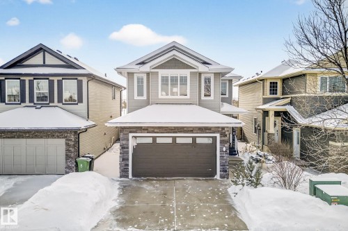 View of front of home with stone siding, a garage, and driveway - 21 Dittrich, Fort Saskatchewan, AB - Outdoor With Facade