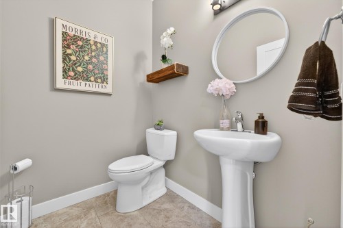 Half bathroom featuring toilet and light tile patterned flooring - 21 Dittrich, Fort Saskatchewan, AB - Indoor Photo Showing Bathroom