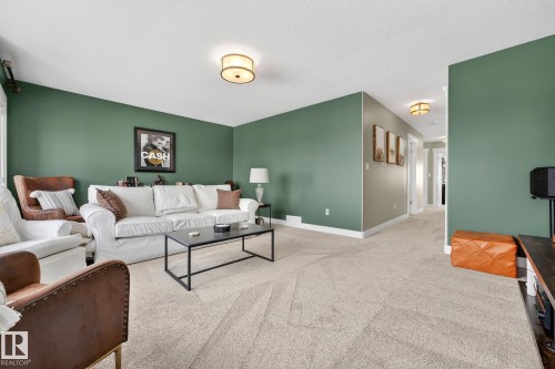 Living room featuring baseboards and carpet - 21 Dittrich, Fort Saskatchewan, AB - Indoor Photo Showing Living Room