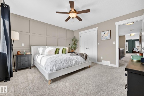 Bedroom featuring a decorative wall, light carpet, and ceiling fan - 21 Dittrich, Fort Saskatchewan, AB - Indoor Photo Showing Bedroom